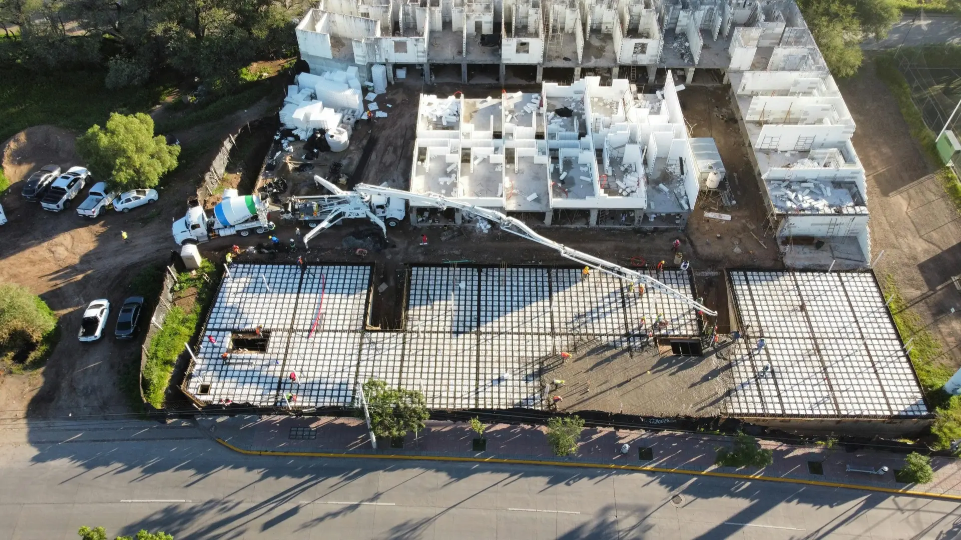 Aerial view of a construction site with foundation and building structures in progress in León, Mexico.